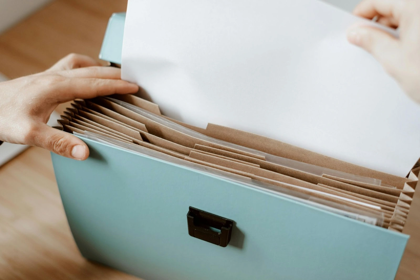Personne en train de ranger les documents contenant des informations financières - comment lire un bilan comptable