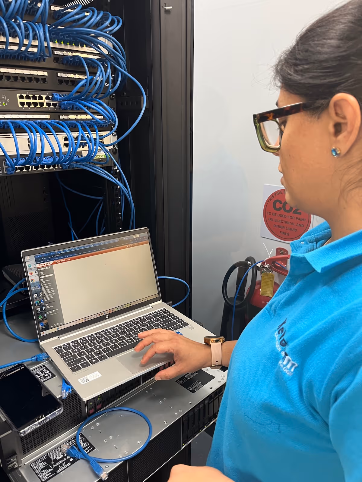 IT Support and Services for a Sydney office using secure business systems with blue cables in a server room.