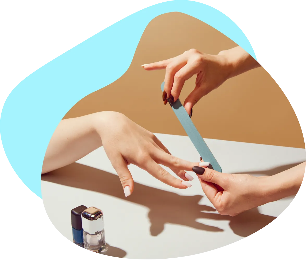 A nail technician working with a client