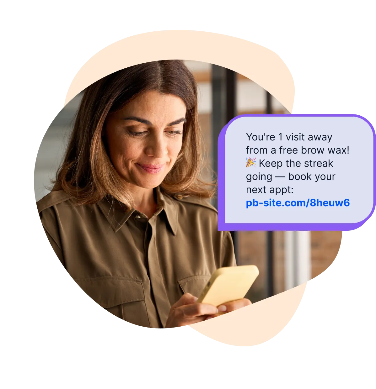 A salon client reading a loyalty reward text on her phone