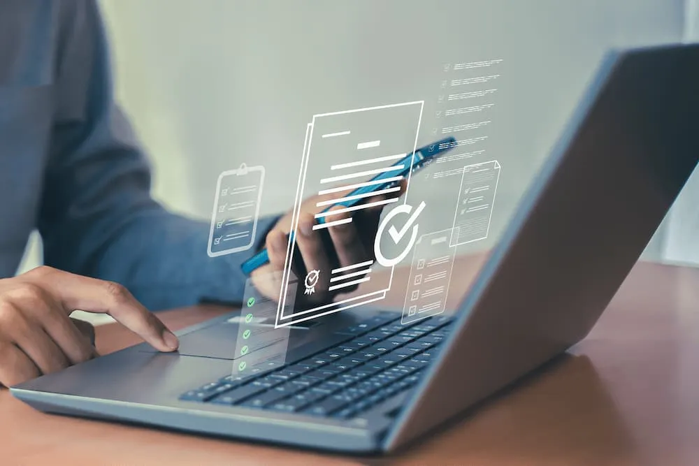 Person using laptop with stylus, surrounded by digital checklists and documents graphics.