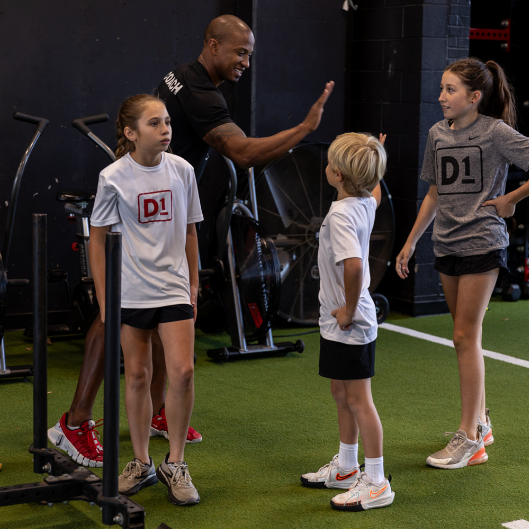 coach giving high five to students