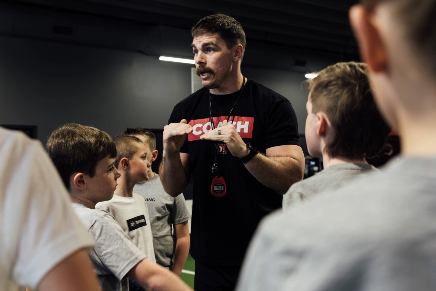 coach giving pep talk to kids