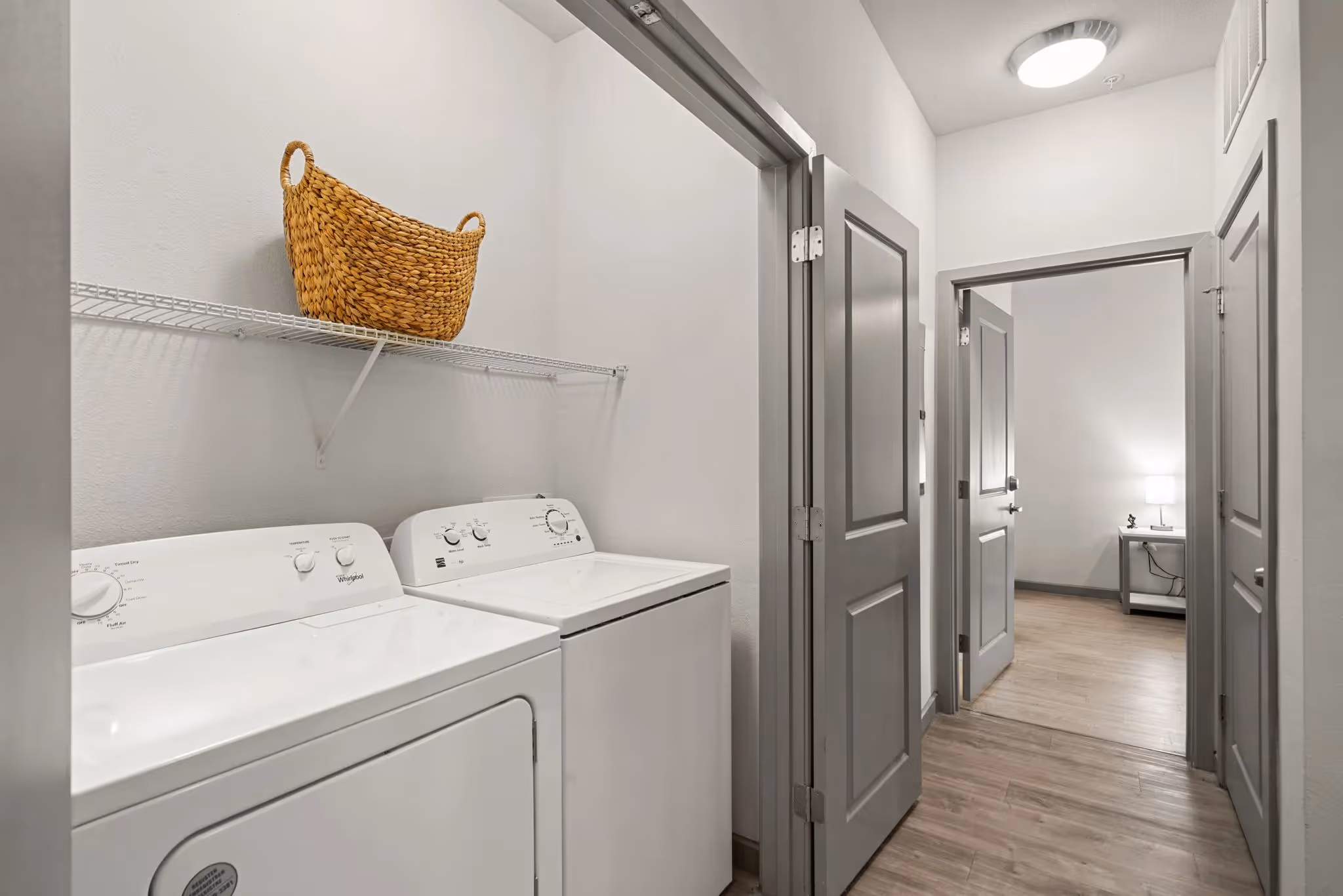 In-unit laundry closet with a washer and dryer, offering convenient amenities at Altitude in Houston, TX.
