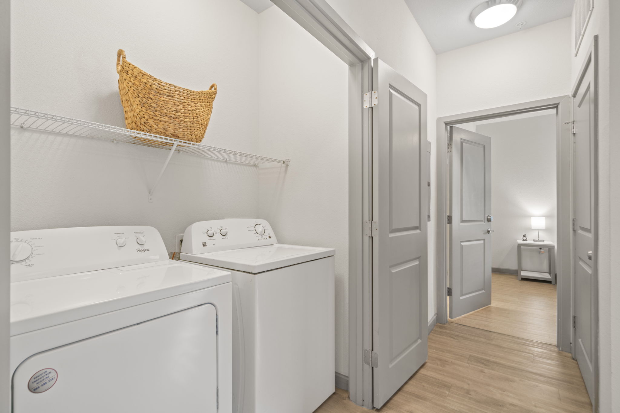 In-unit laundry closet with a washer and dryer, offering convenient amenities at Altitude in Houston, TX.