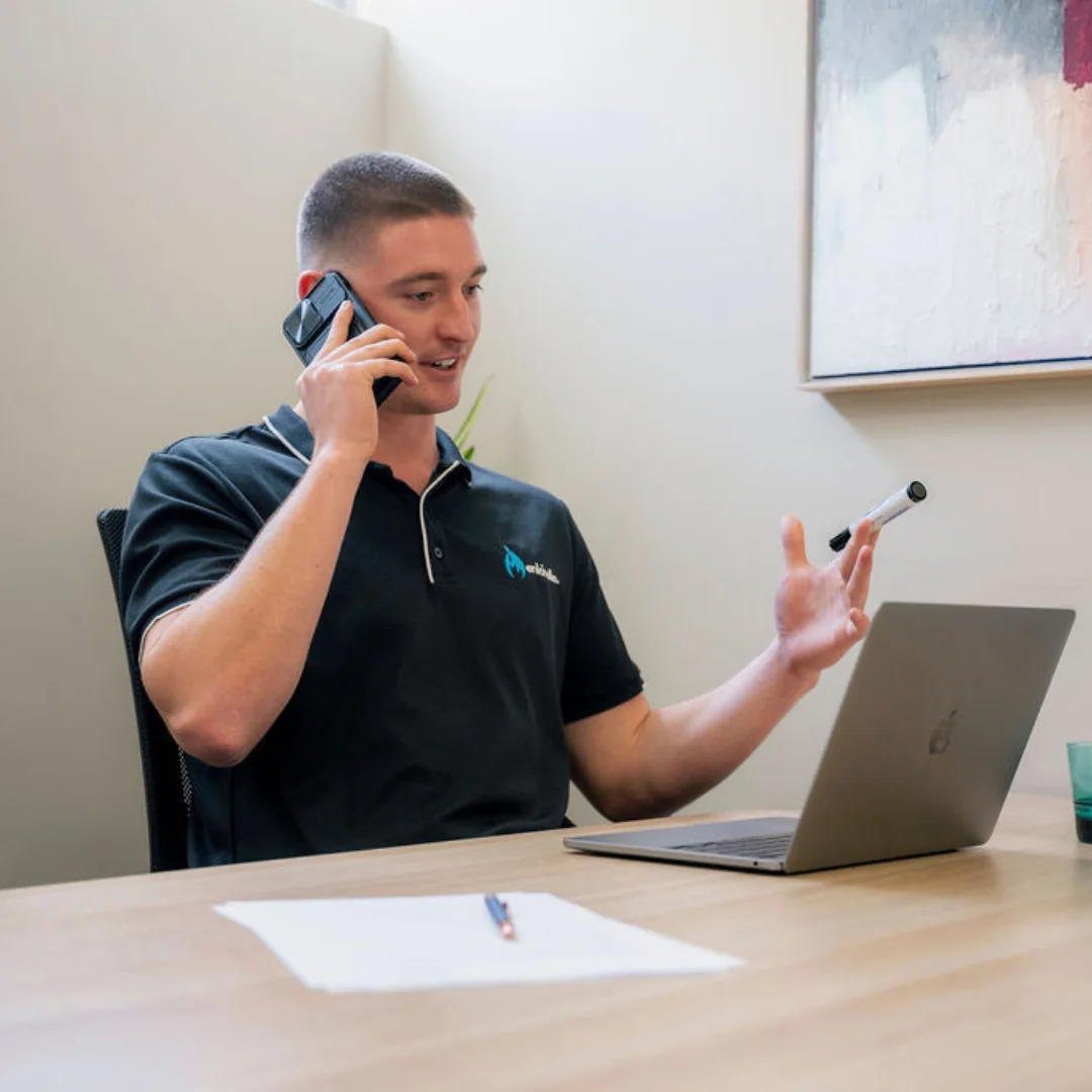 An Enkindle Group founder taking a client call at a laptop