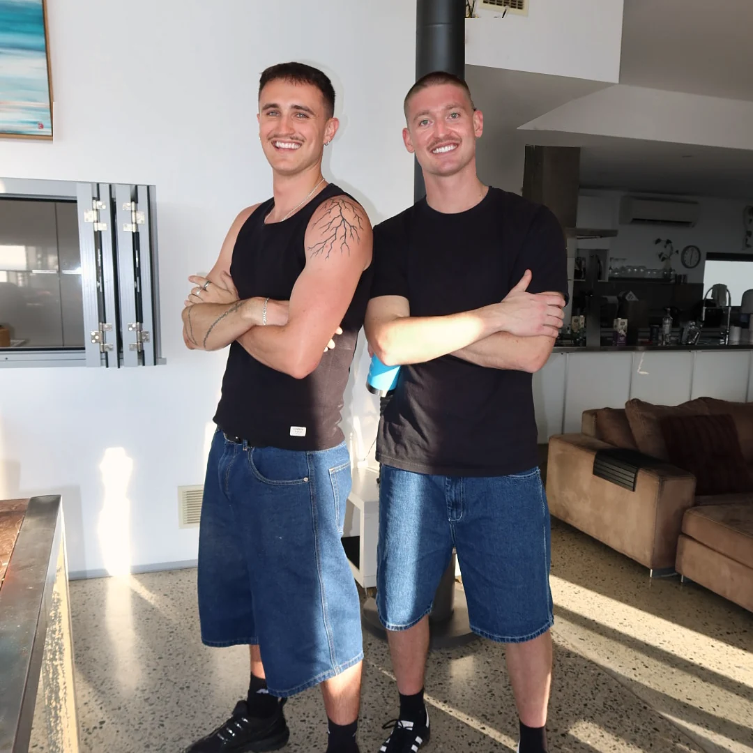 Enkindle Group founders Harvie Williams and Kobi Martin standing with arms crossed