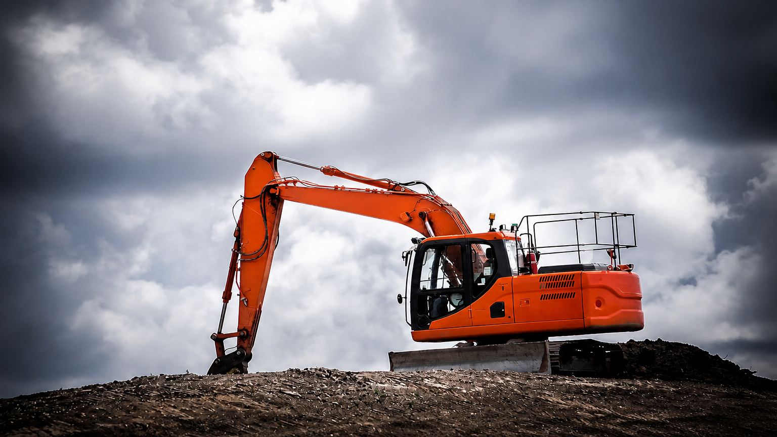 Orange excavator on a dirt mound under a cloudy sky at a construction site.