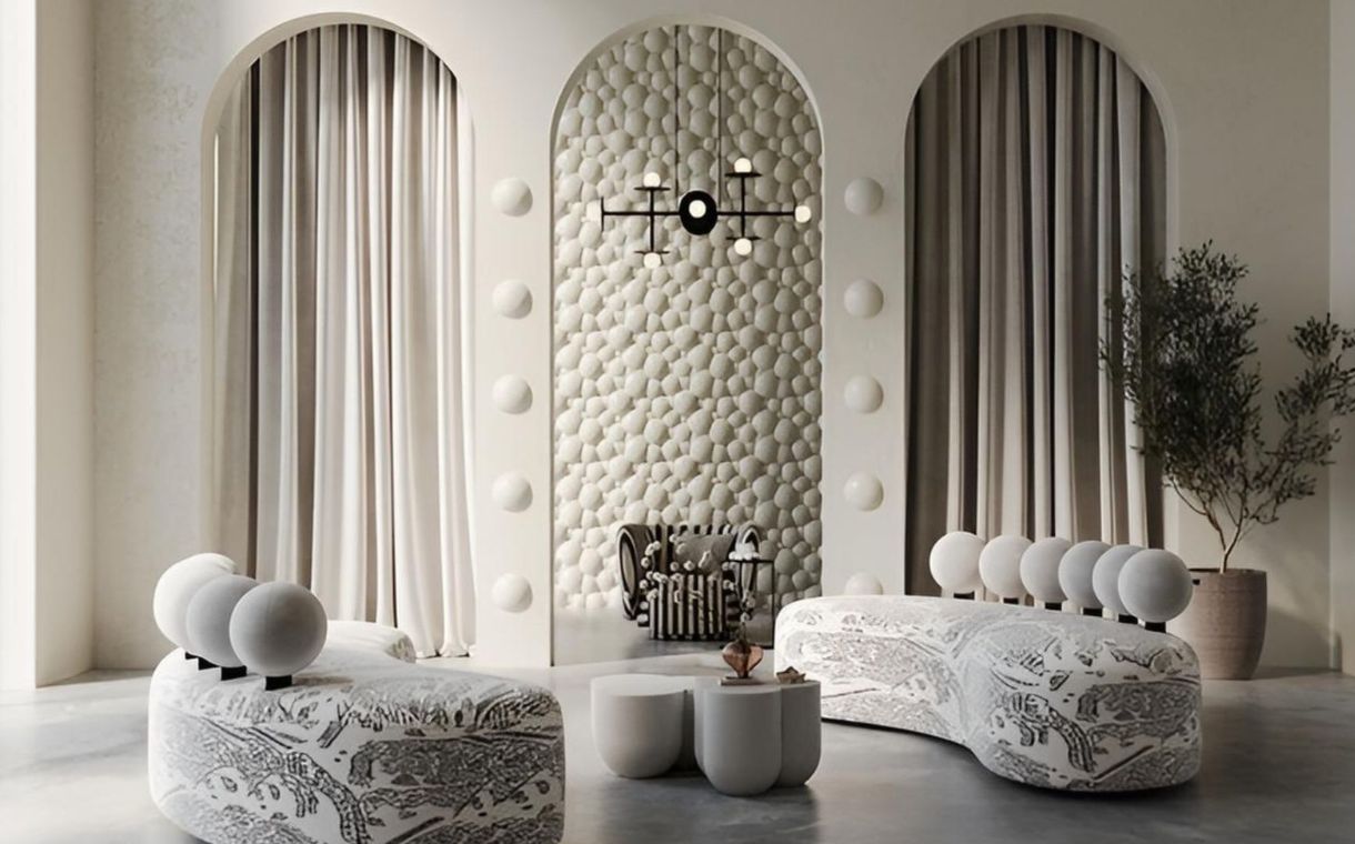 Modern living room with curved patterned sofas, round backrests, pebble-textured wall, and an armchair.