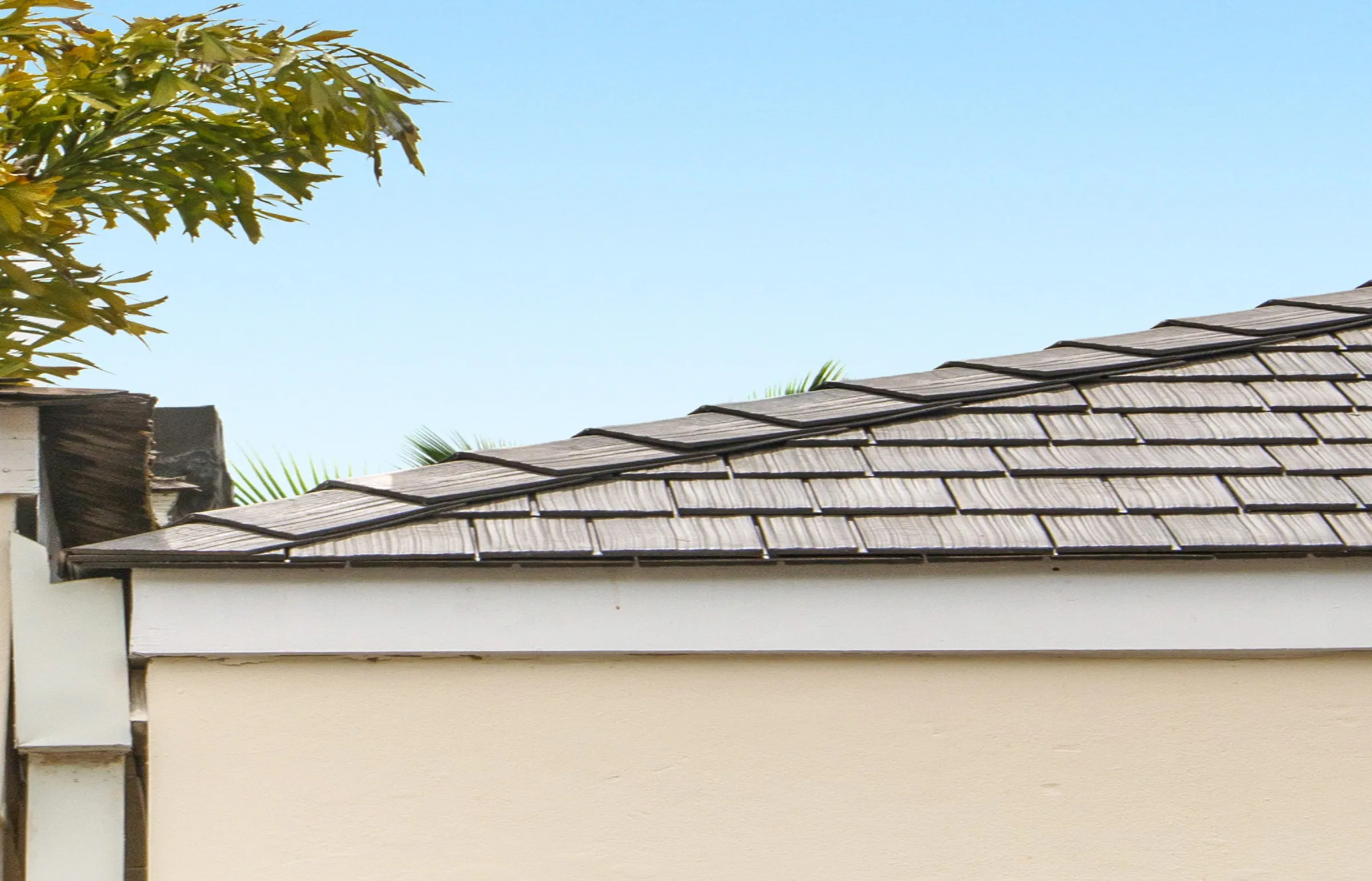 Close-up of a brown shake-style roof edge showing overlapping textured rows.
