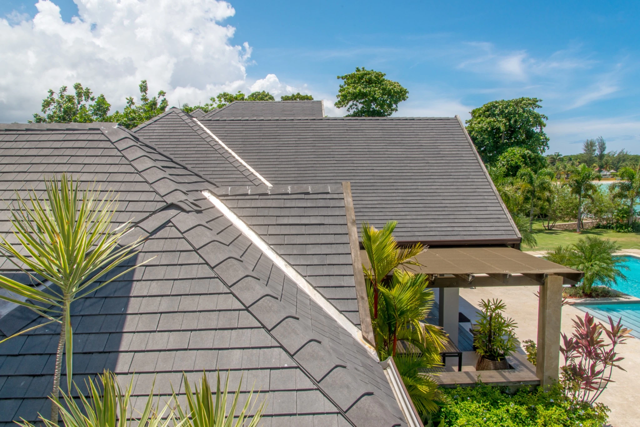Enviroshingle Aged Cedar roof on a lakeside home surrounded by tropical plants