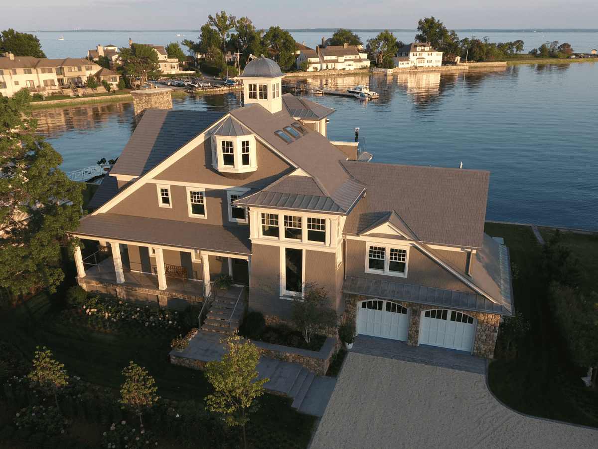 Enviroshake synthetic cedar roof tiles installed on a luxury lakeside home