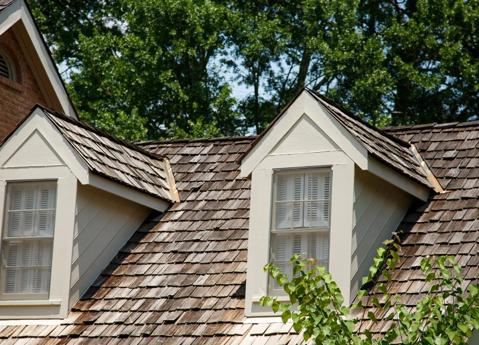 A traditional natural cedar shake roofing system, with two dormers