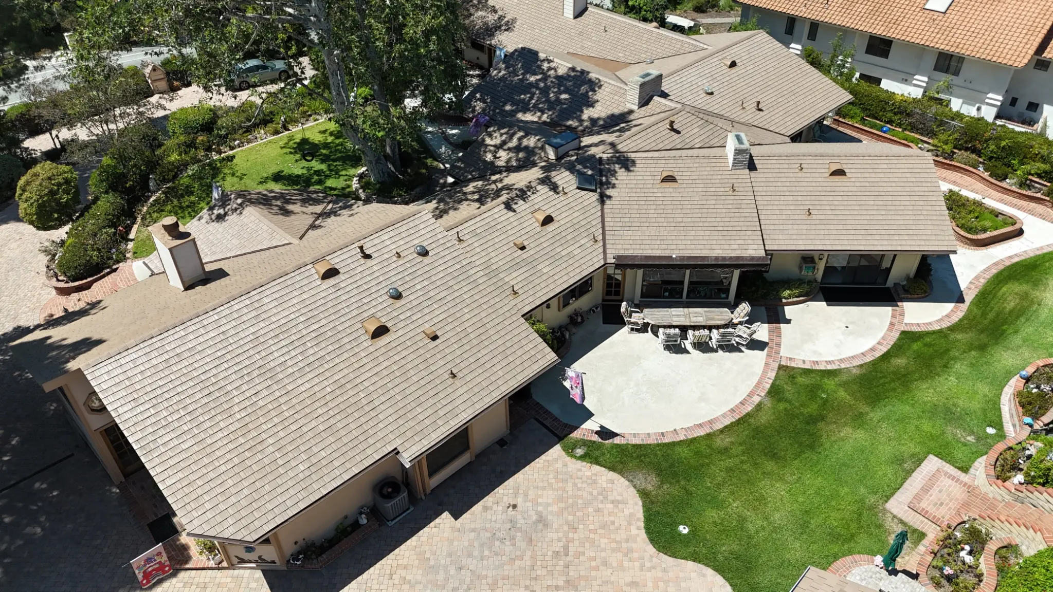 Aerial view of a single-story California ranch-style home with Disney Brown Enviroshake roof tiles