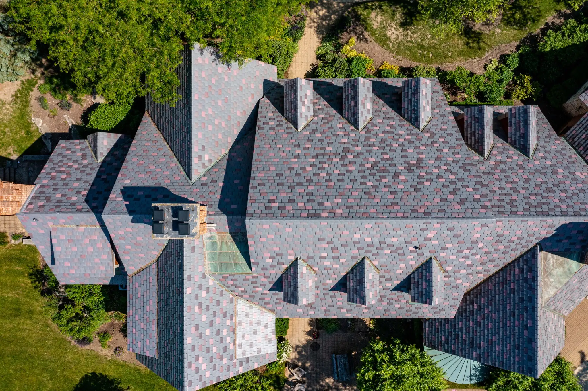 Aerial view of a multi-gabled home with an Enviroslate Multi-Tone roof
