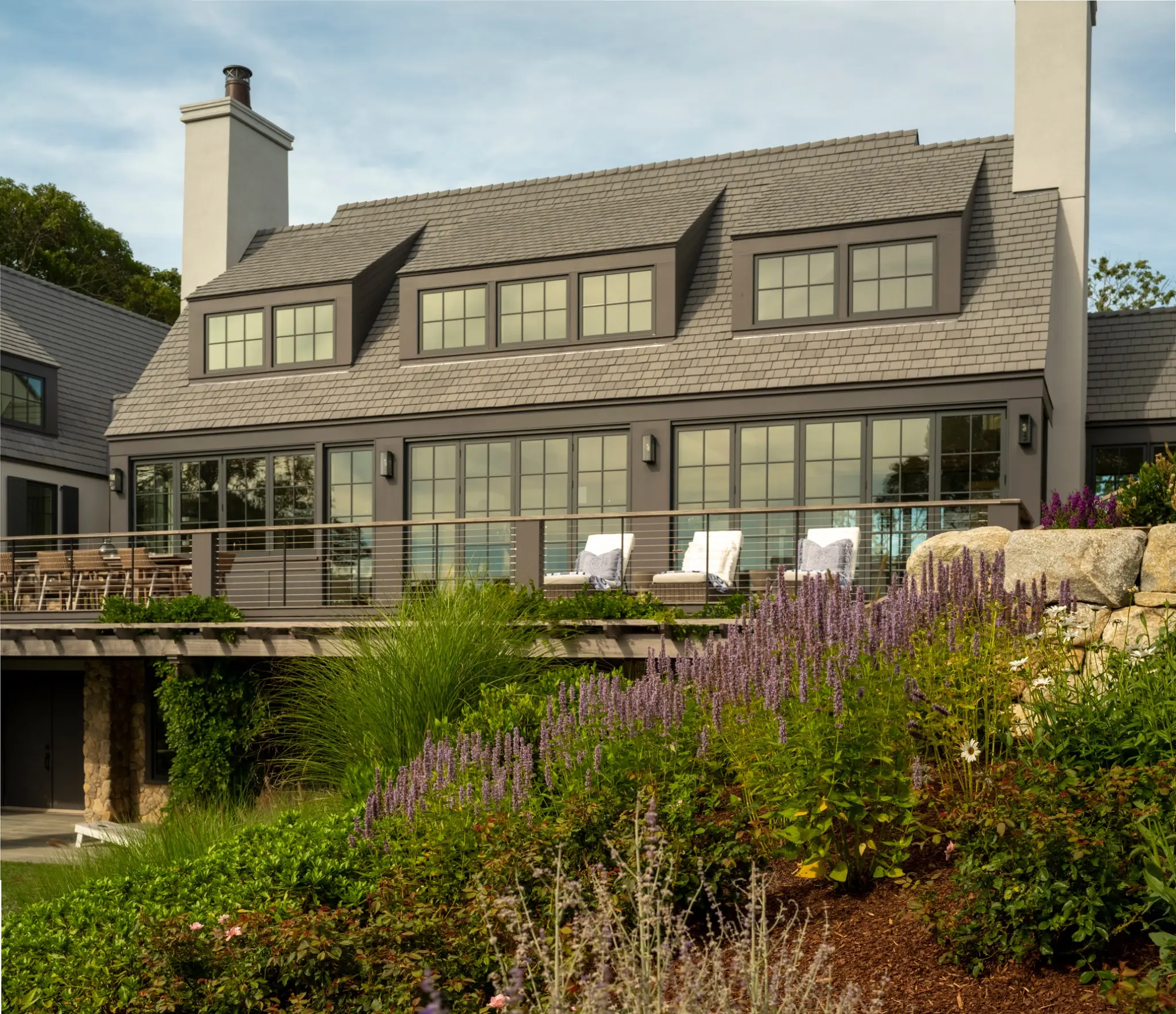 Hillside home with a terrace, gardens and an Enviroshake roof