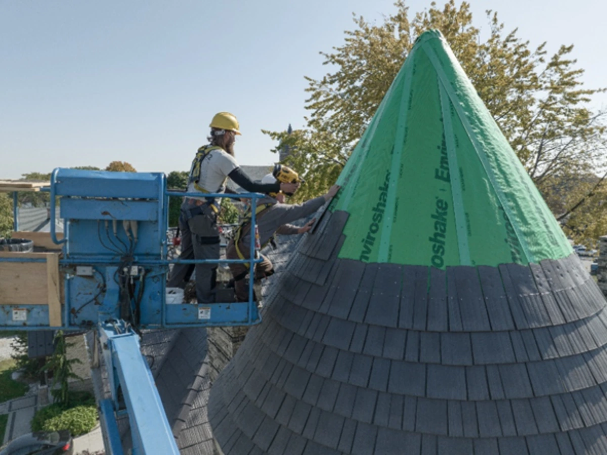 Enviroshake composite cedar shake roofing being installed on a steep conical roof by professional roofing contractors.
