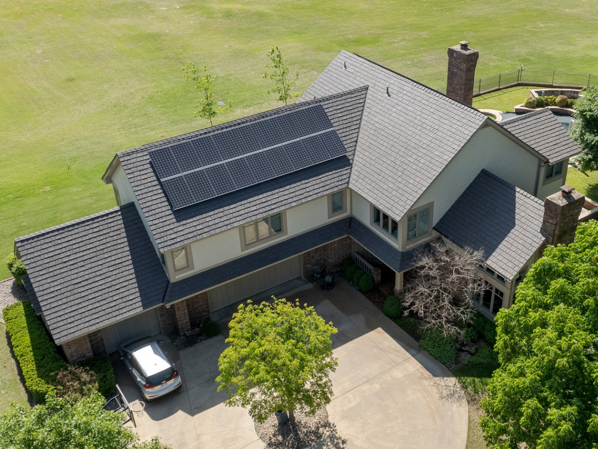 Aged Cedar Enviroshake composite roofing with solar panels on a large residential home.