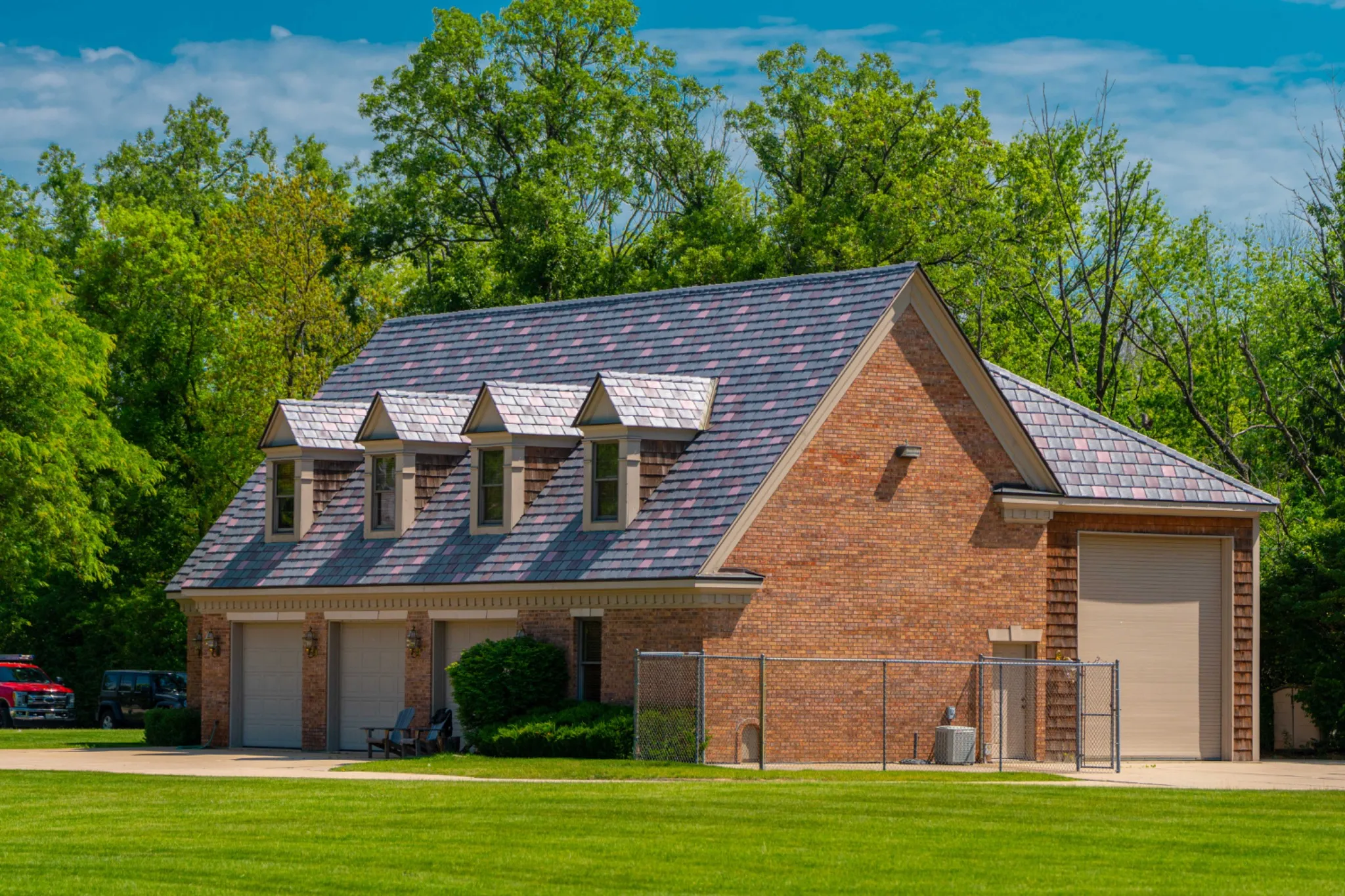 Brick carriage house with dormers and an Enviroslate Multi-Tone roof