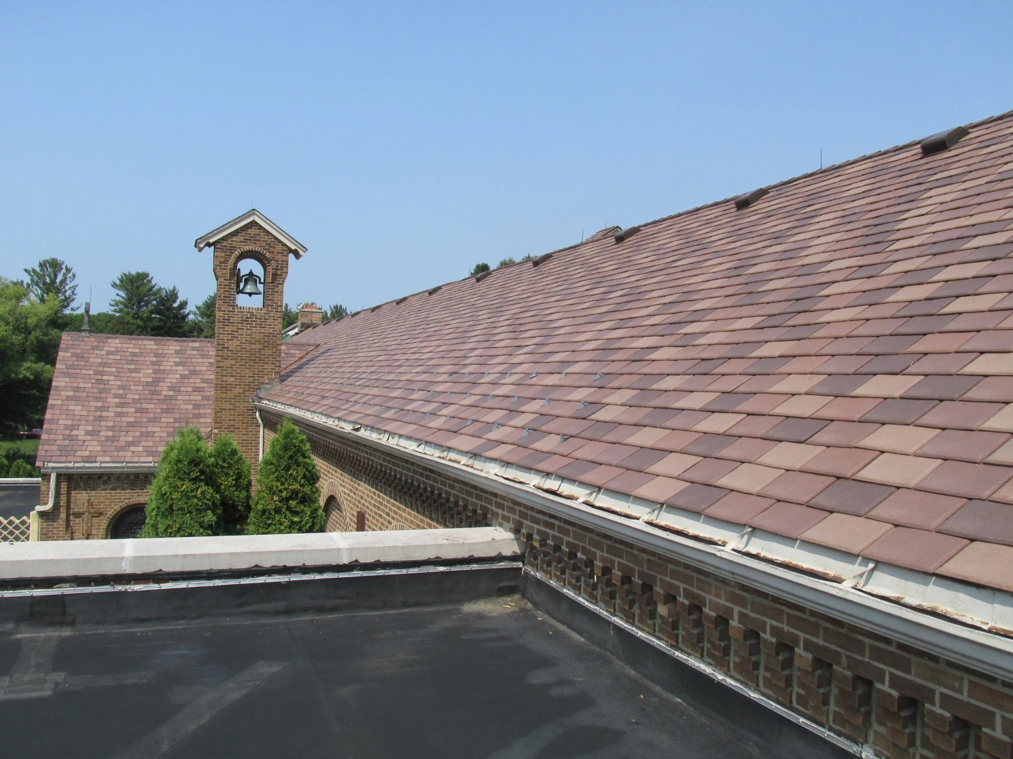 Enviroshake composite cedar roofing on a historic brick church, complementing the traditional architecture and bell tower with the natural texture and character of cedar.
