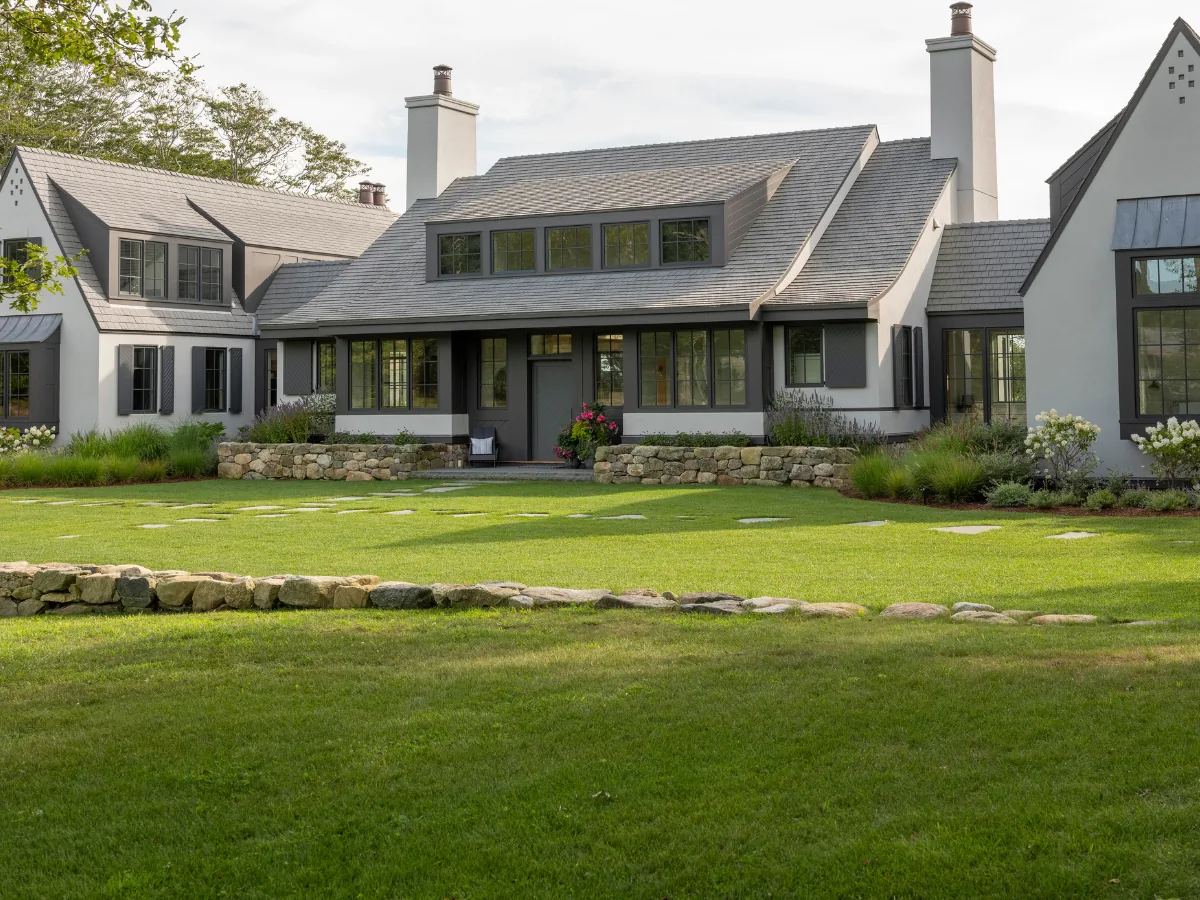 Aged Cedar Enviroshake composite cedar shake roofing on a luxury home with steep gables, dormer windows and landscaped grounds.