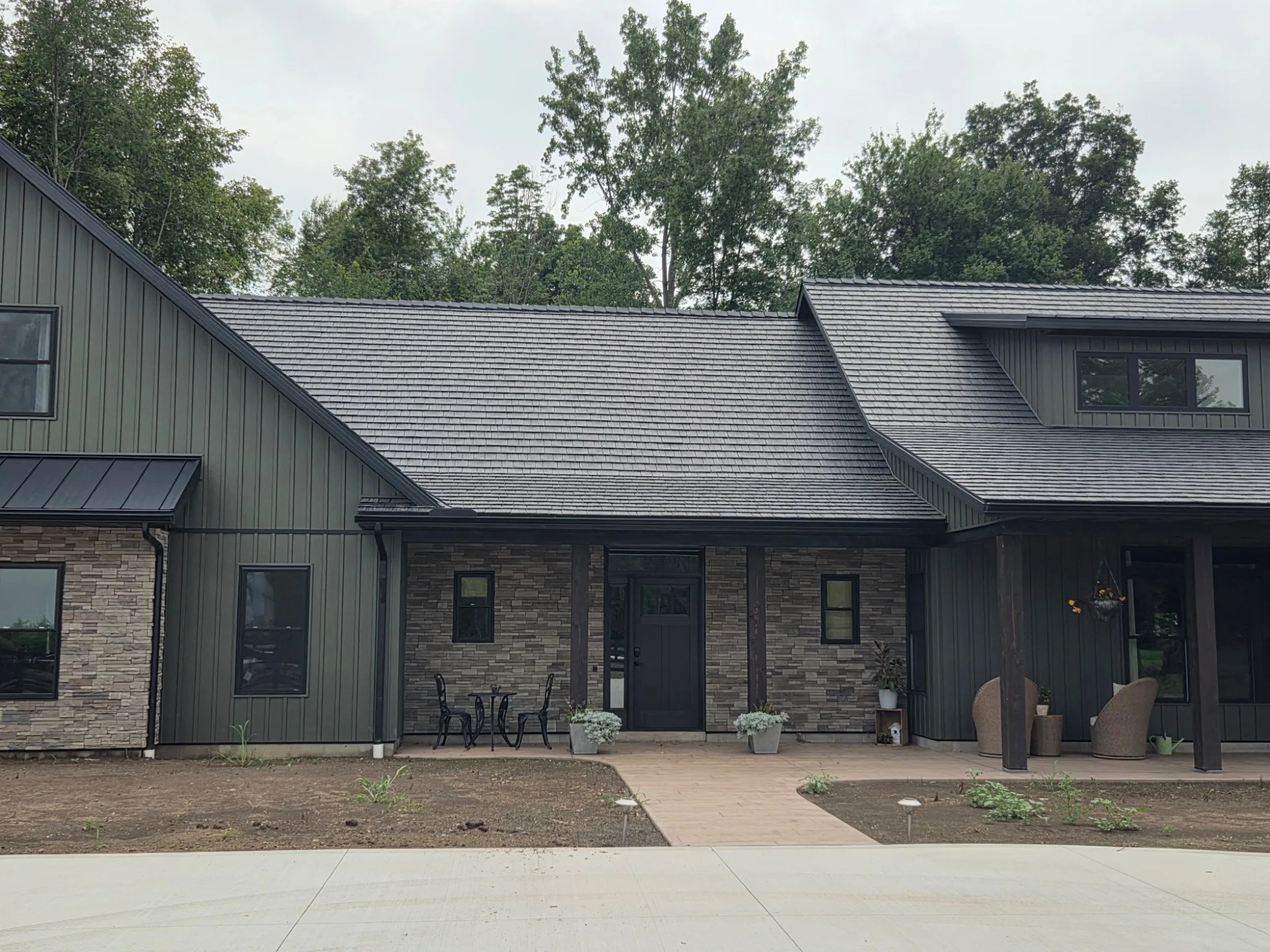 Onyx Black Enviroshake composite cedar shake roofing on a contemporary home with dark siding and stone accents.