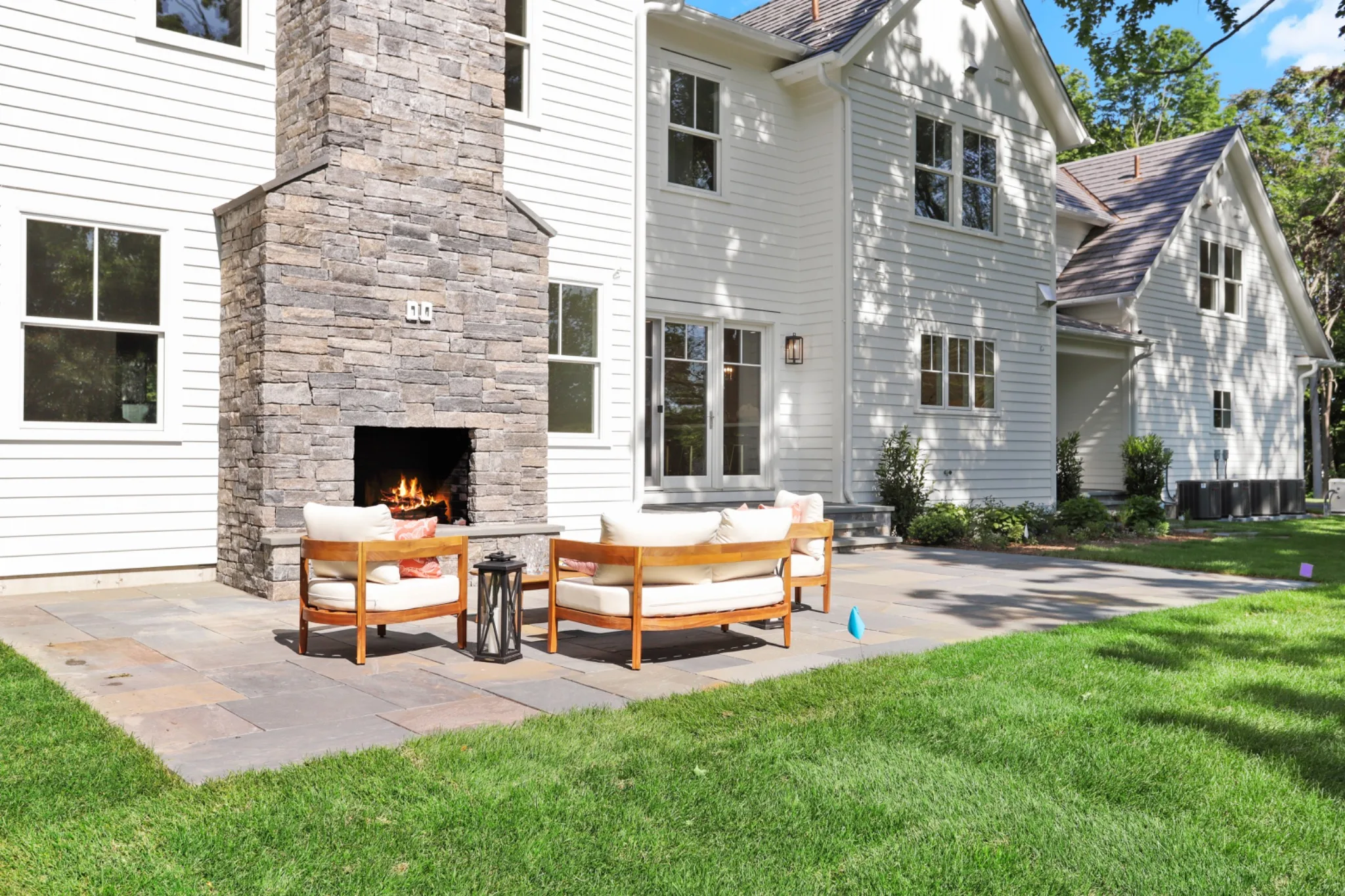 Enviroshake composite cedar shake roofing on a large luxury home with white siding, stone accents and multiple gables.