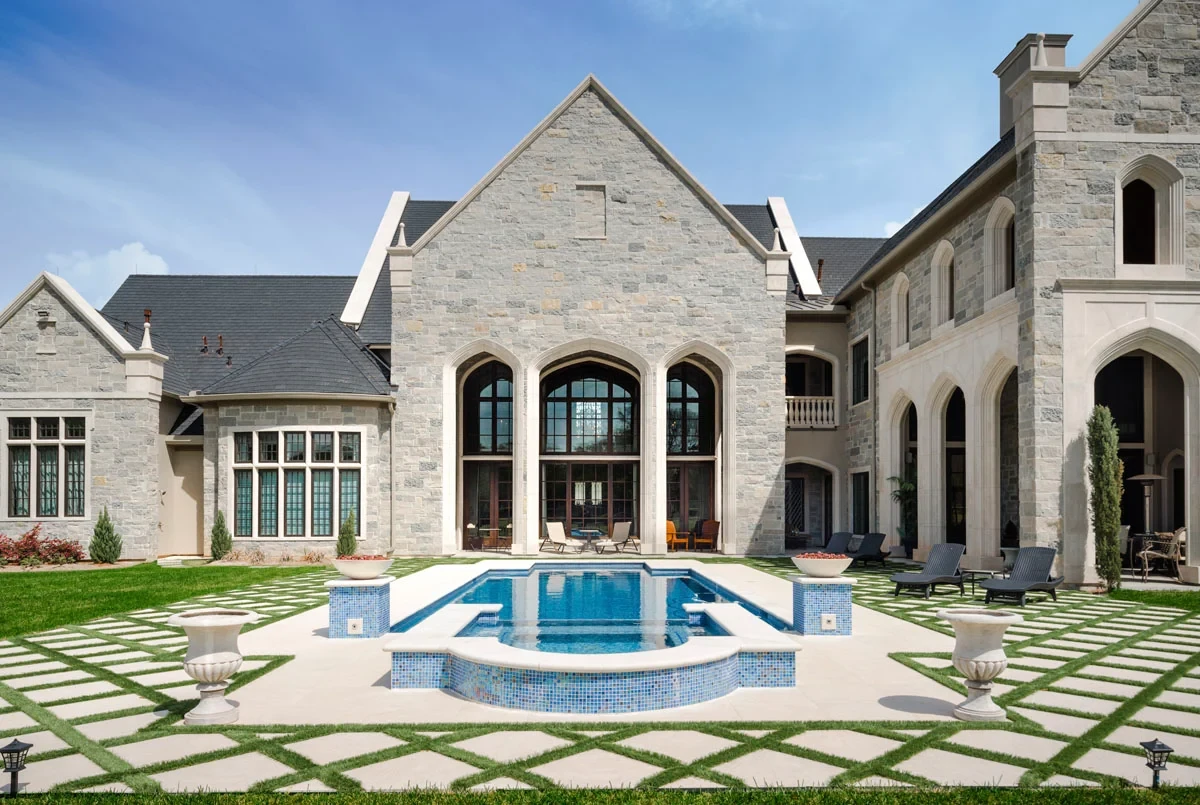 Luxury stone estate with Enviroslate composite slate roofing overlooking a landscaped courtyard and swimming pool.