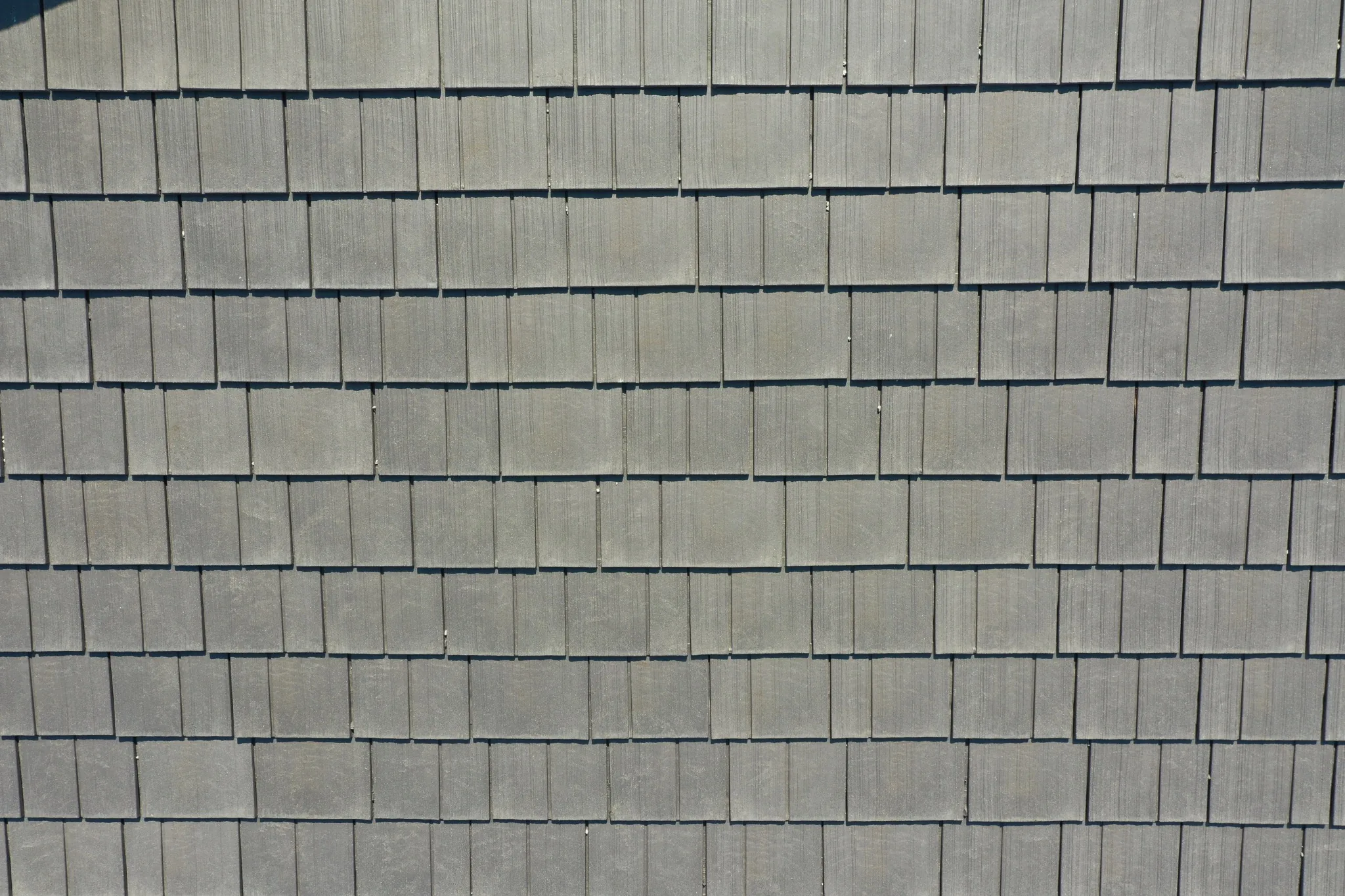 Close-up of Aged Cedar Enviroshake composite cedar shake roofing showing realistic wood grain and staggered shake courses.
