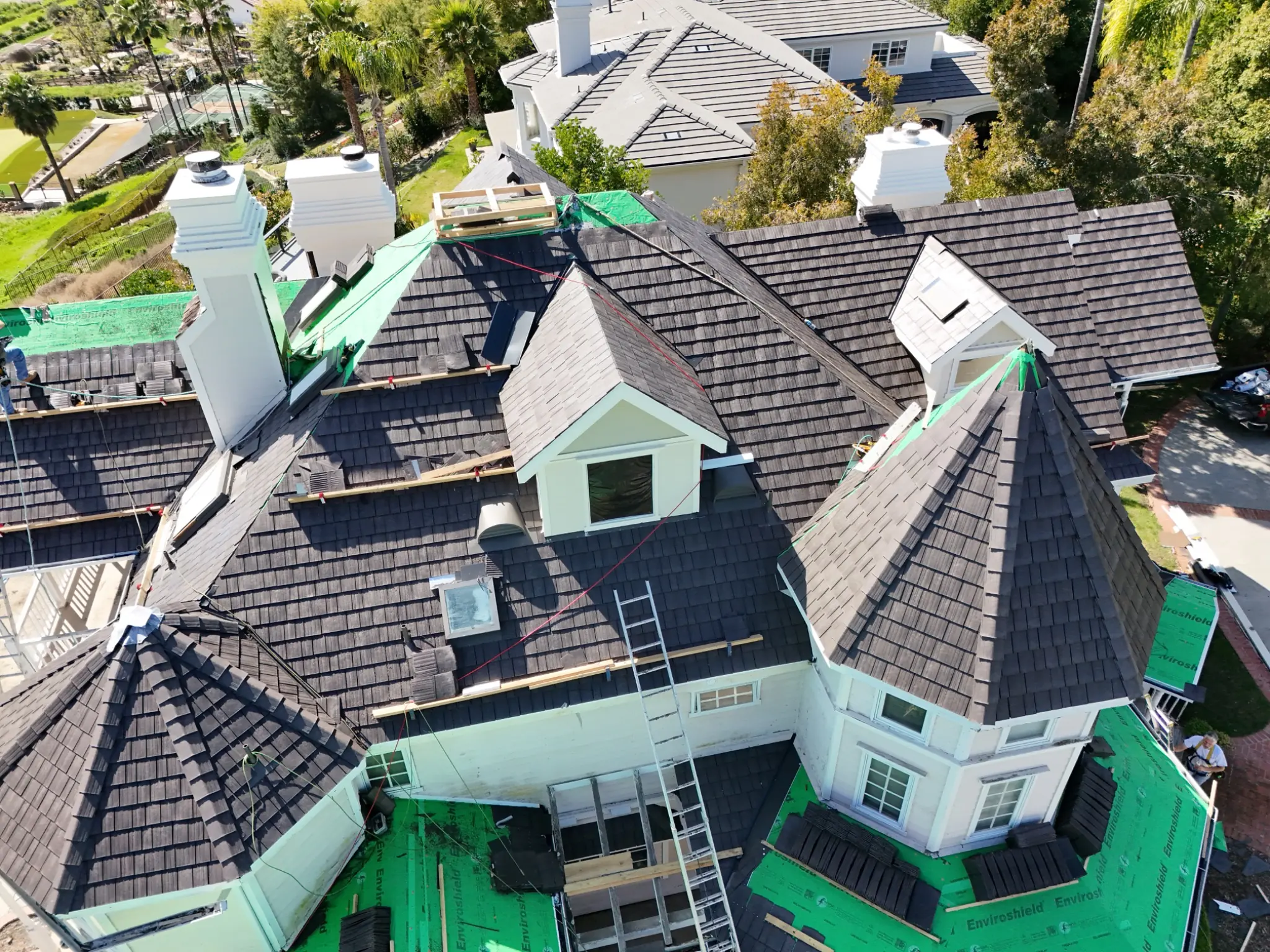 Aerial view of an Enviroshake composite cedar shake roof installation on a large residential home.