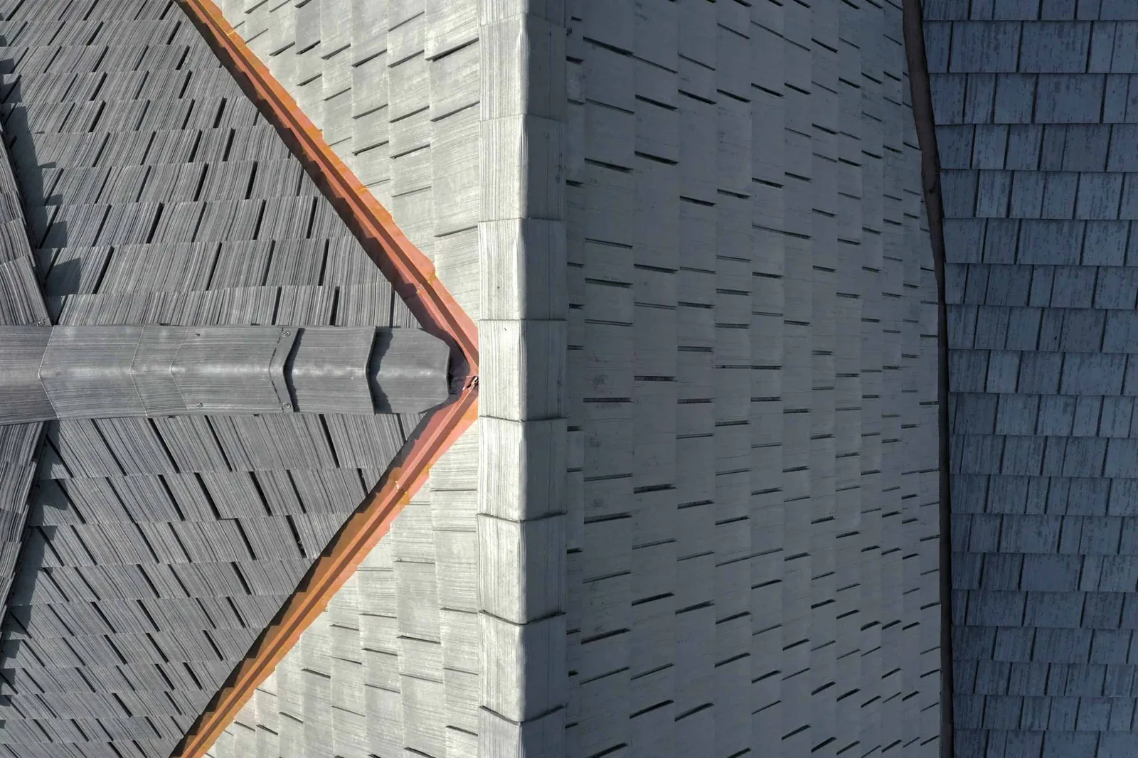 Close-up of Silvered Cedar Enviroshake roofing showing detailed shake texture, ridge caps and copper roof accents.