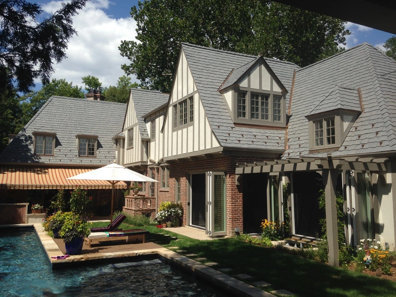 A tudor style home with Enviroshake Aged Cedar roofing tiles in a staggered style