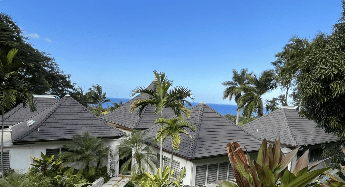 Aged Cedar Enviroshake composite cedar shake roofing on a tropical coastal home overlooking the ocean.