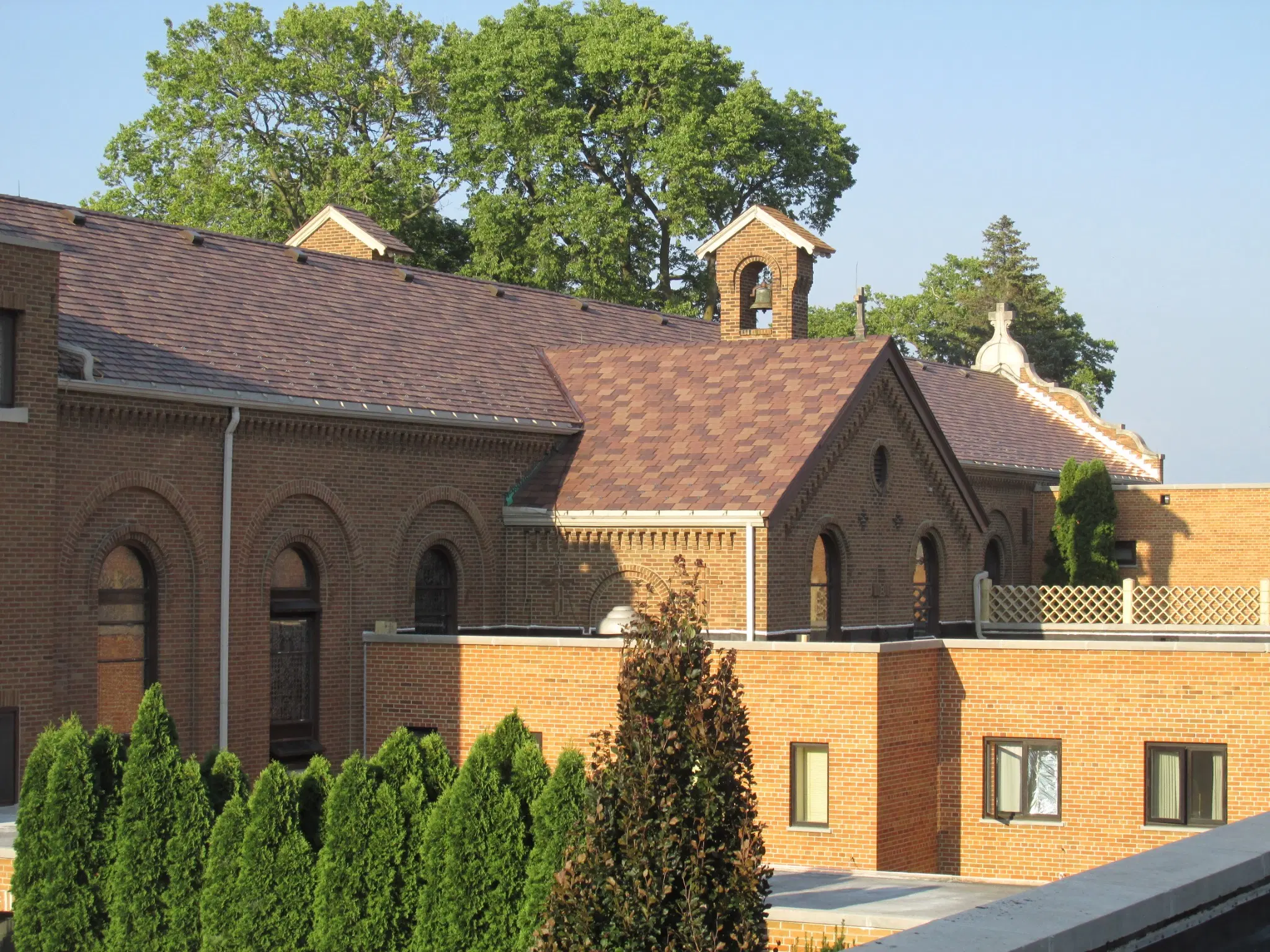 Multi-Tone Enviroslate composite slate roofing on a large brick church with traditional architectural details.