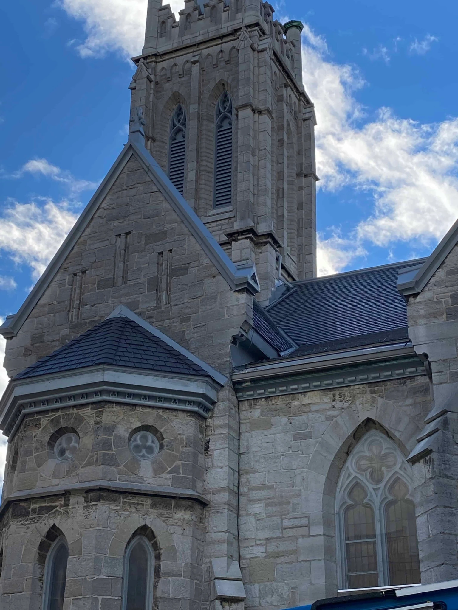 Aged Cedar Enviroshake composite cedar roofing on a historic stone church, complementing the Gothic architecture and steep rooflines.