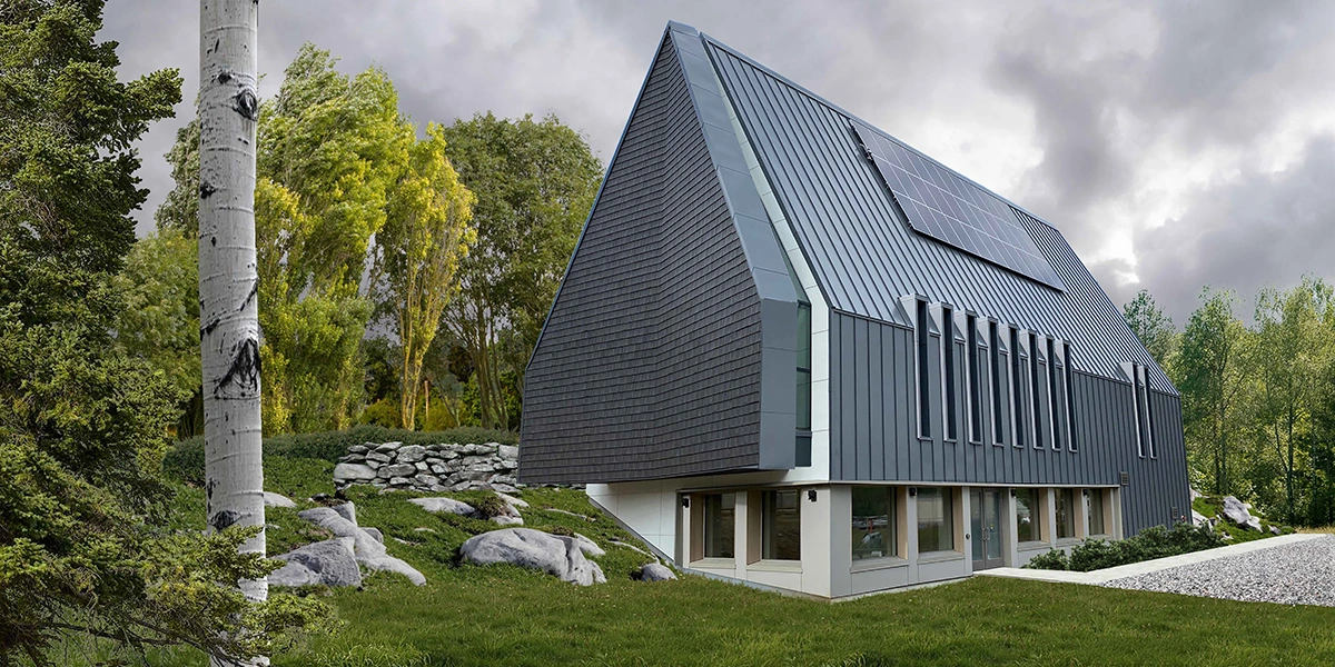 Enviroshake composite cedar used as exterior wall cladding on a contemporary cultural center, paired with standing-seam metal roofing and integrated solar panels.