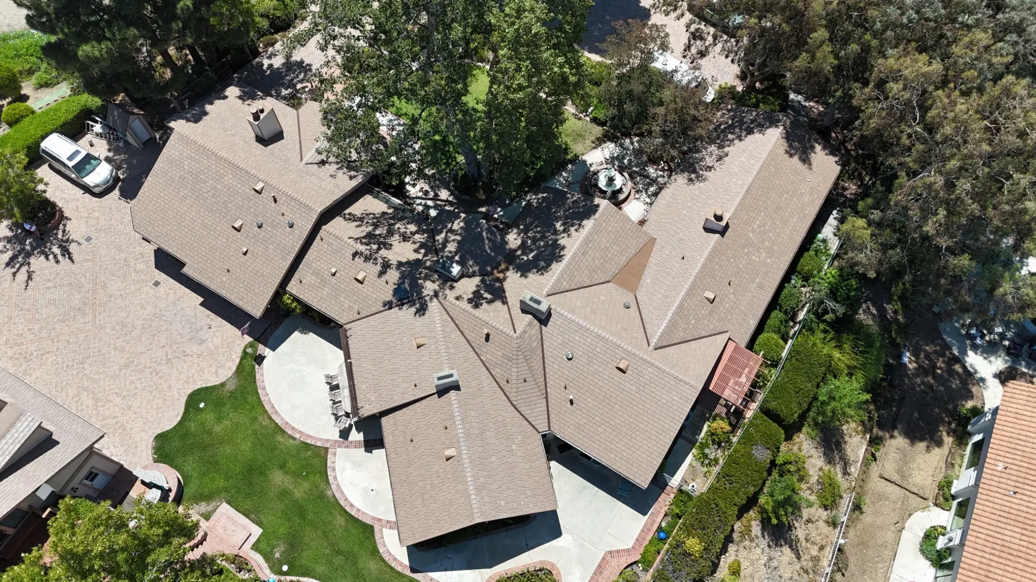 Disney Brown Enviroshake composite cedar shake roofing on a large California home with multiple rooflines and mature landscaping.
