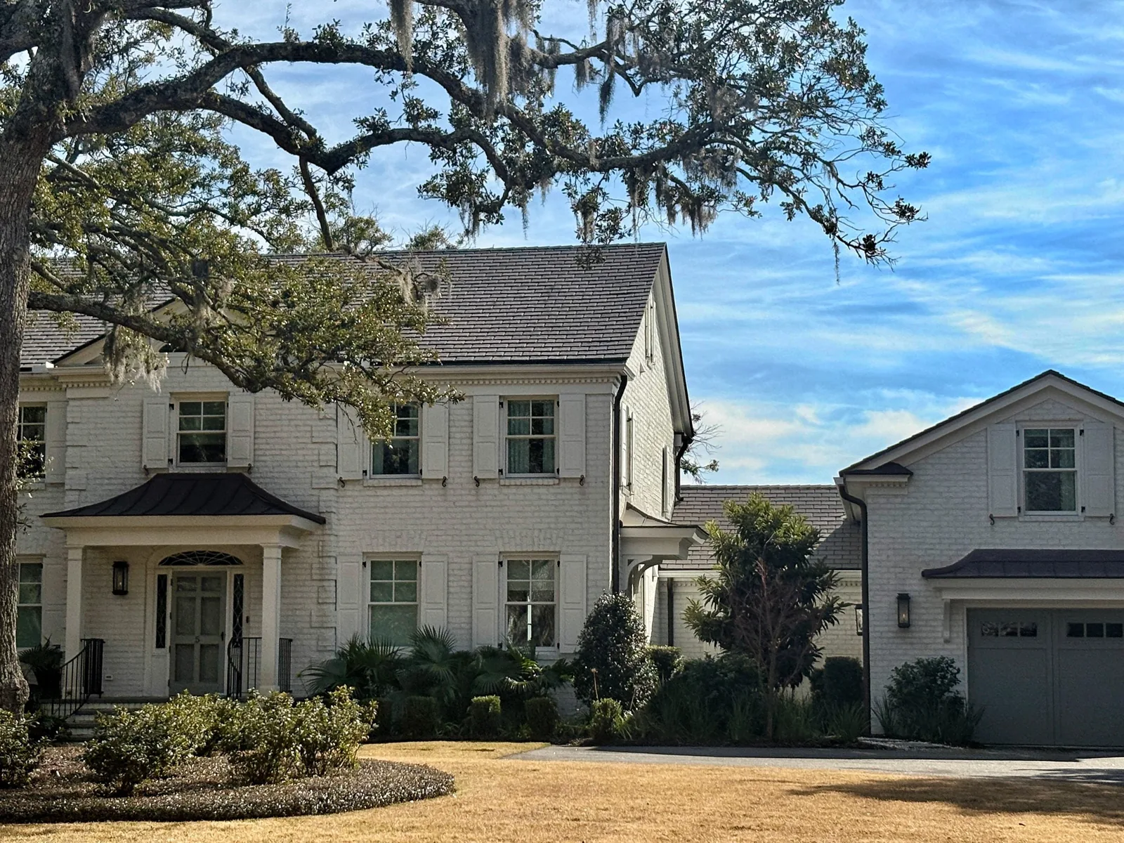 Grey Enviroslate composite slate roofing on a white brick home with traditional architecture.