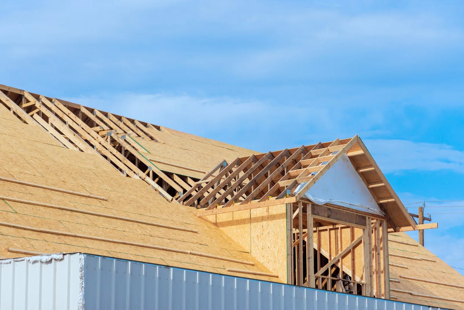 New roof decking and framing on a house under construction