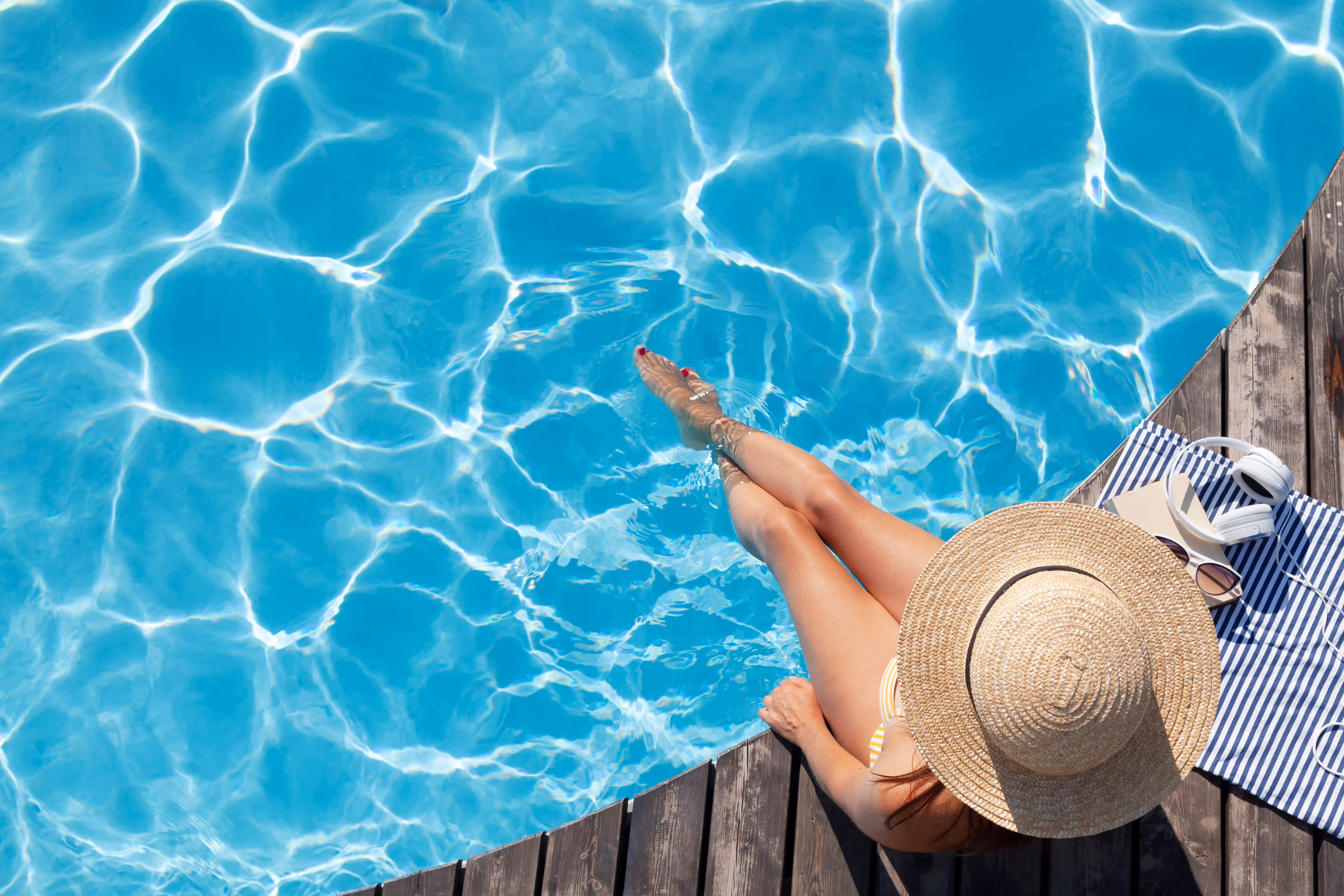 Woman sitting poolside tock photo
