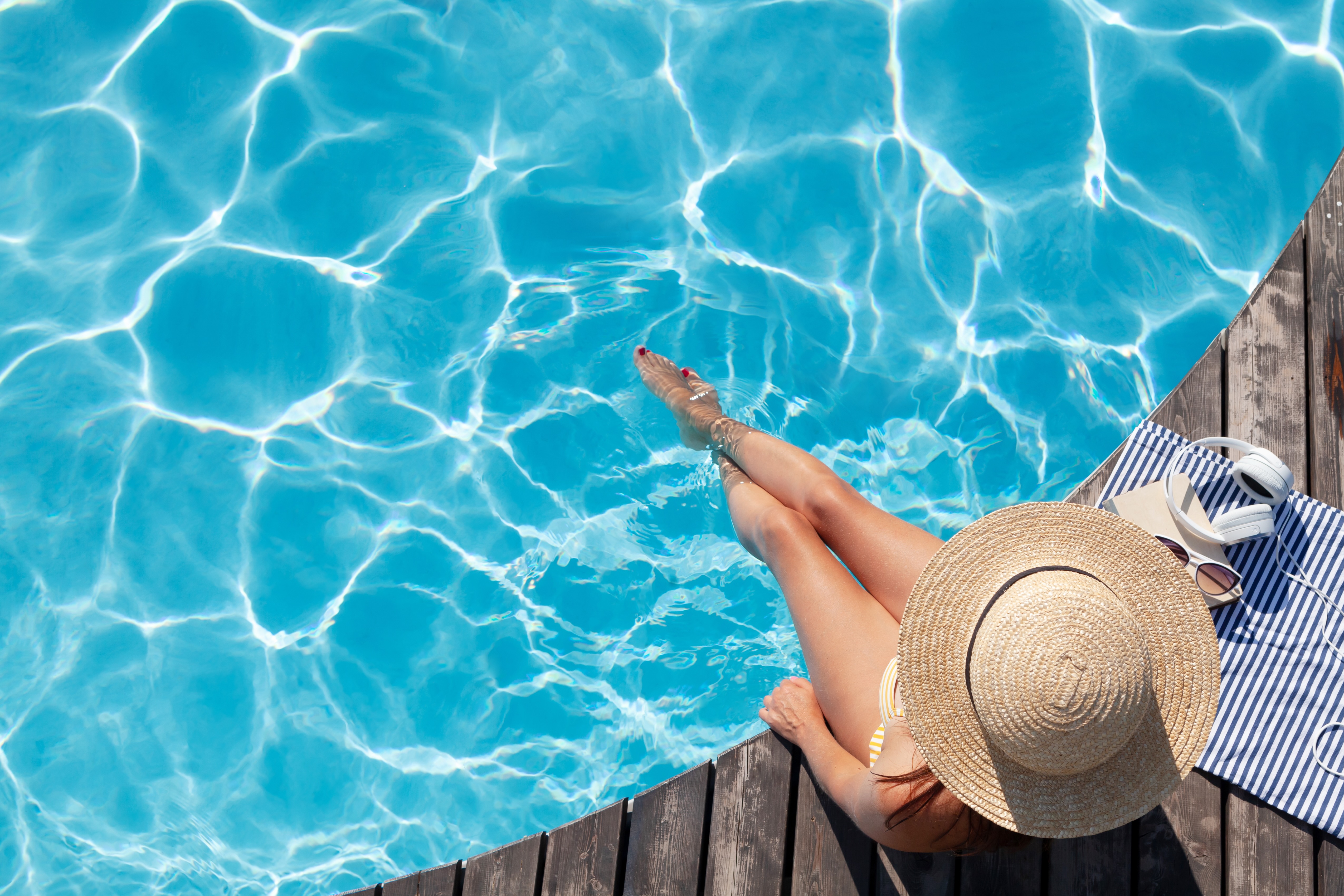 Woman sitting poolside tock photo