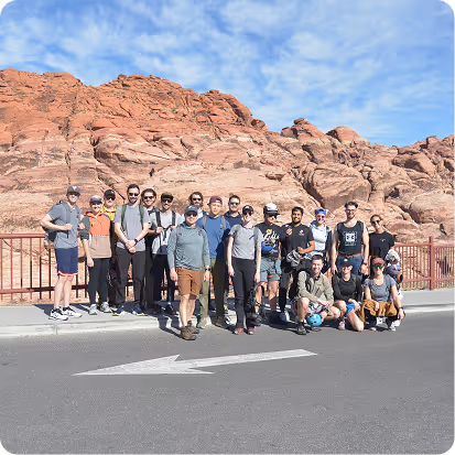 A group of people standing on the side of a road.