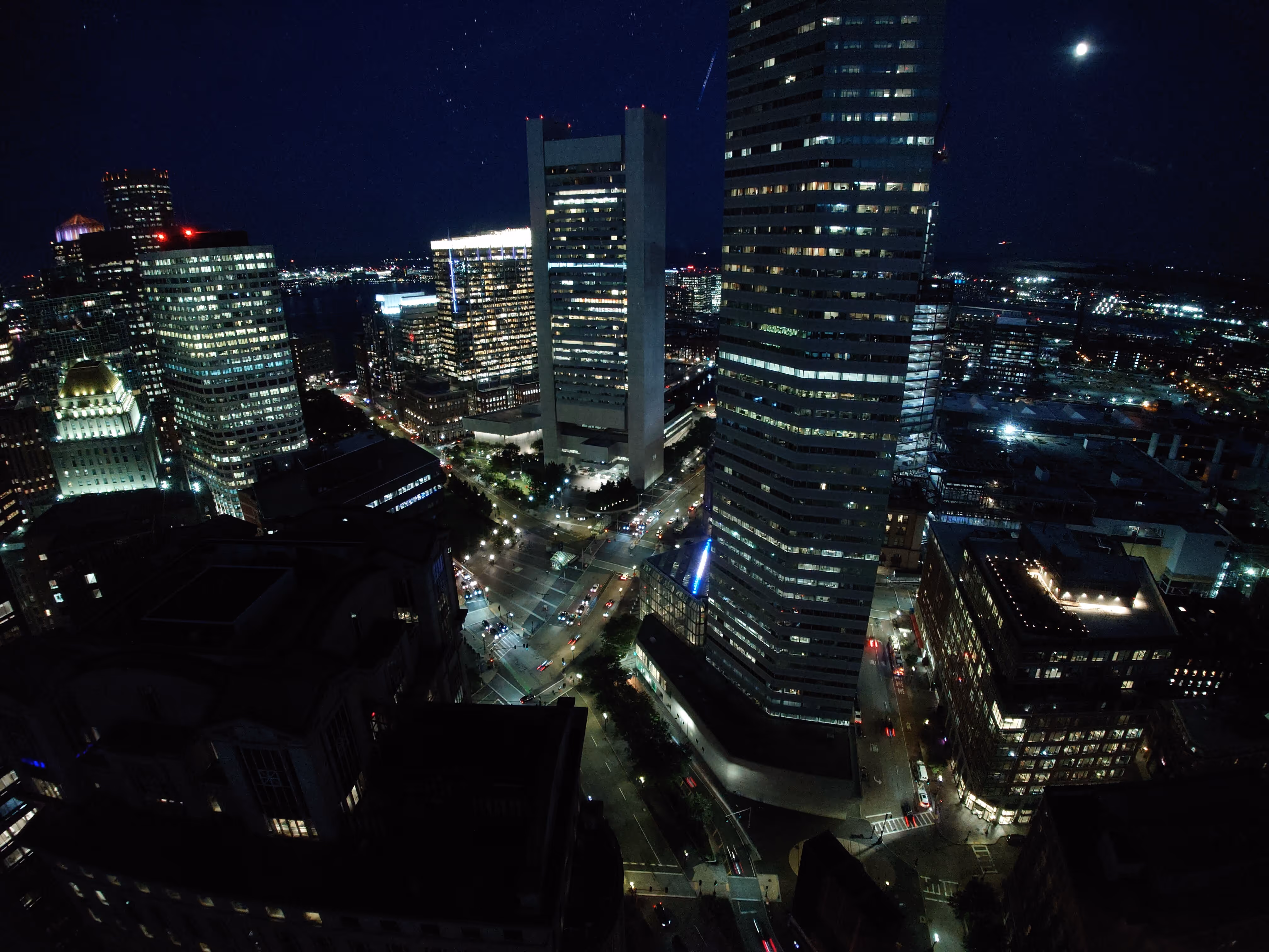 A view of a city at night from the top of a building.