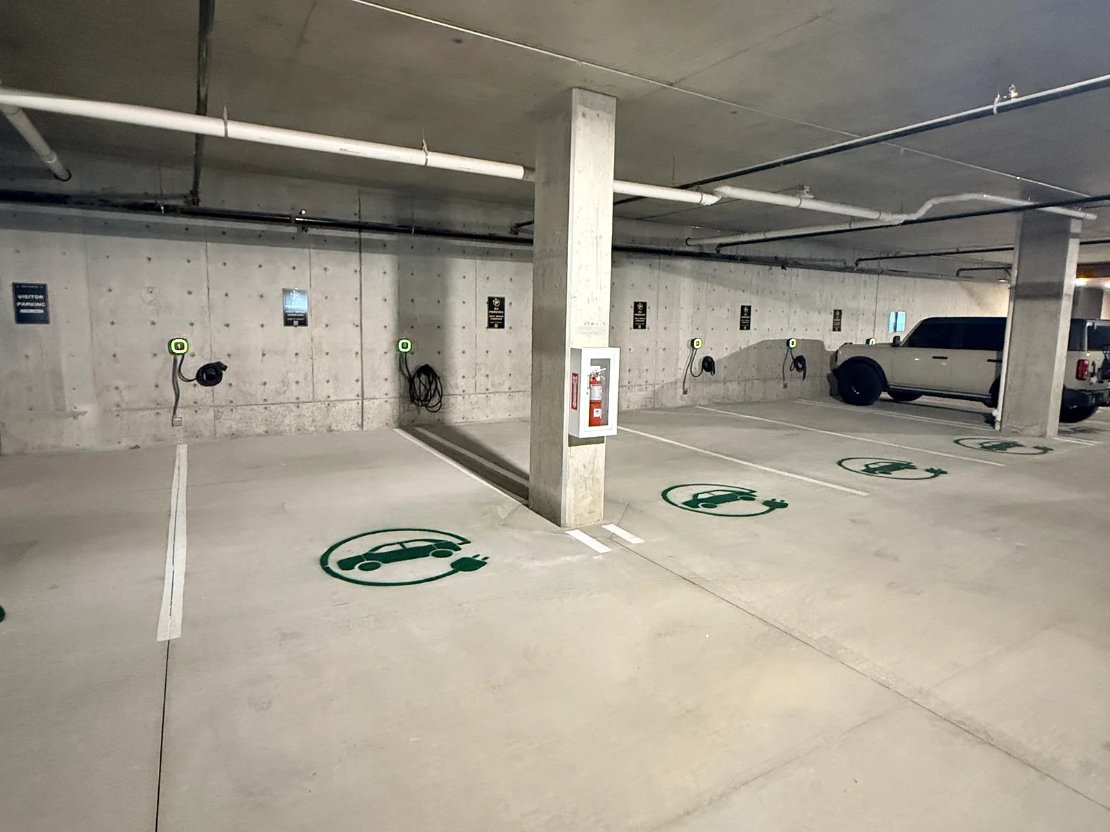 Parking garage with wall-mounted EV chargers and painted EV stall markings
