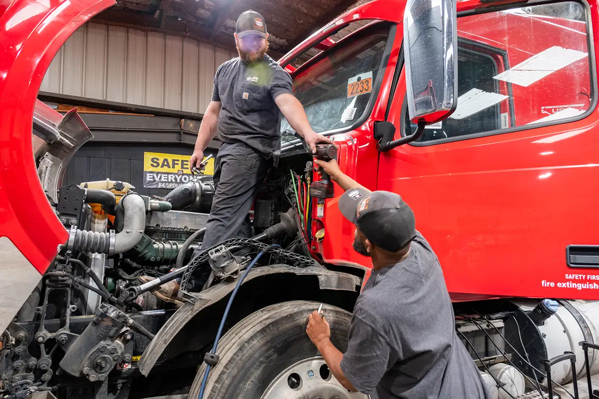 Diesel mechanic performing hydraulic repairs