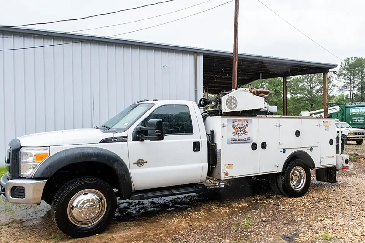 Mobile diesel mechanic performing emergency roadside assistance services