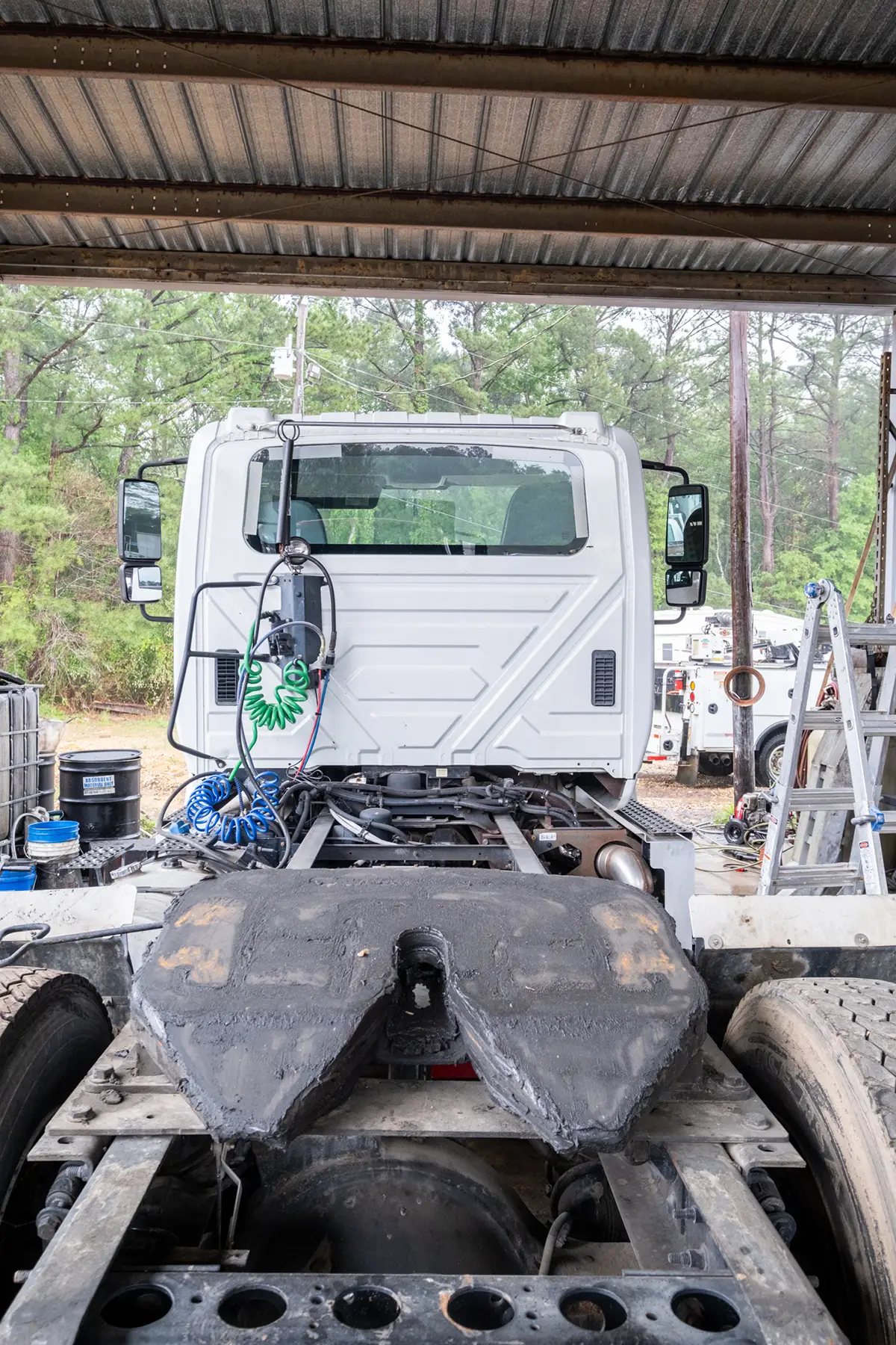 Mechanic performing driveline repair services