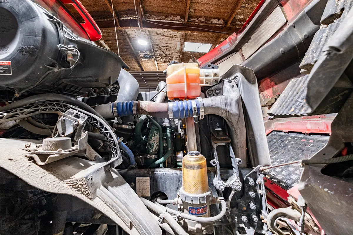 Mechanic performing diesel engine repairs