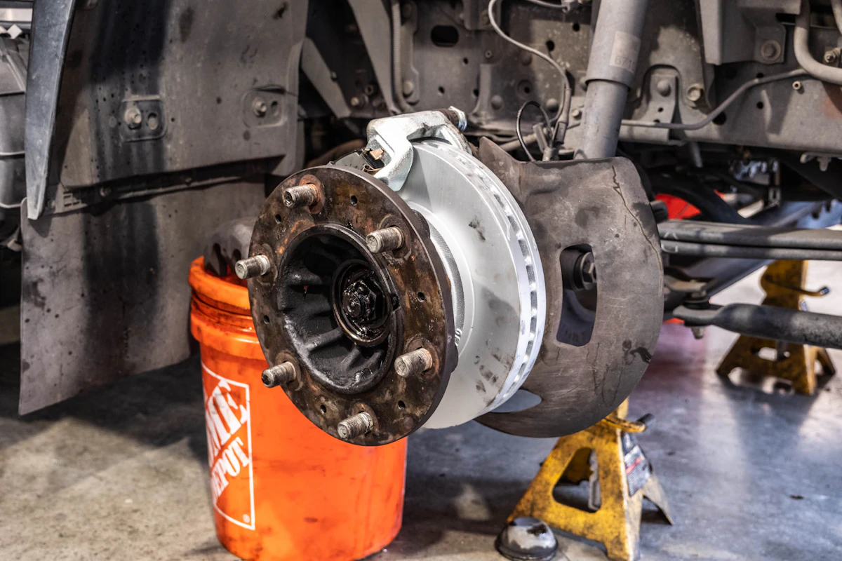 Mechanic performing brake repairs on semi truck