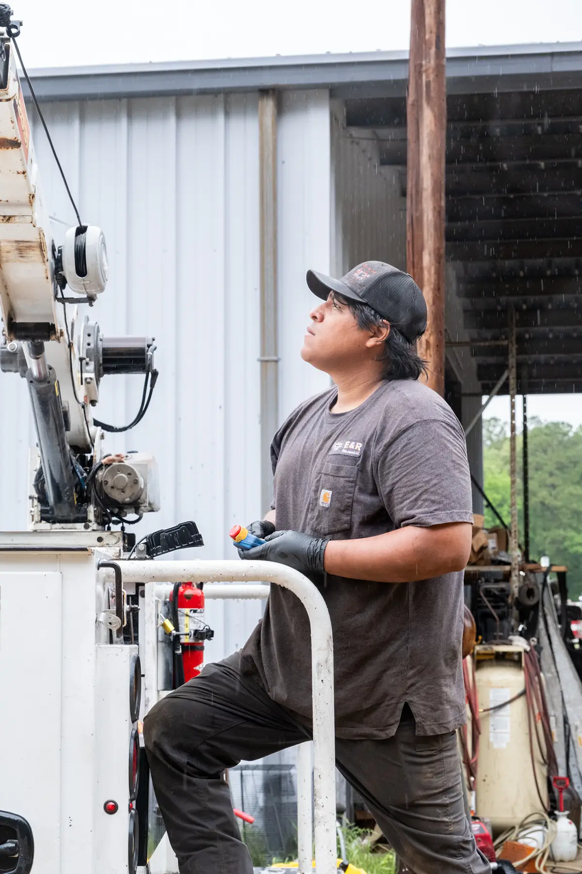 Diesel mechanic performing suspension repairs on semi truck